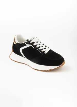 Black sneakers with gold detail and thick sole