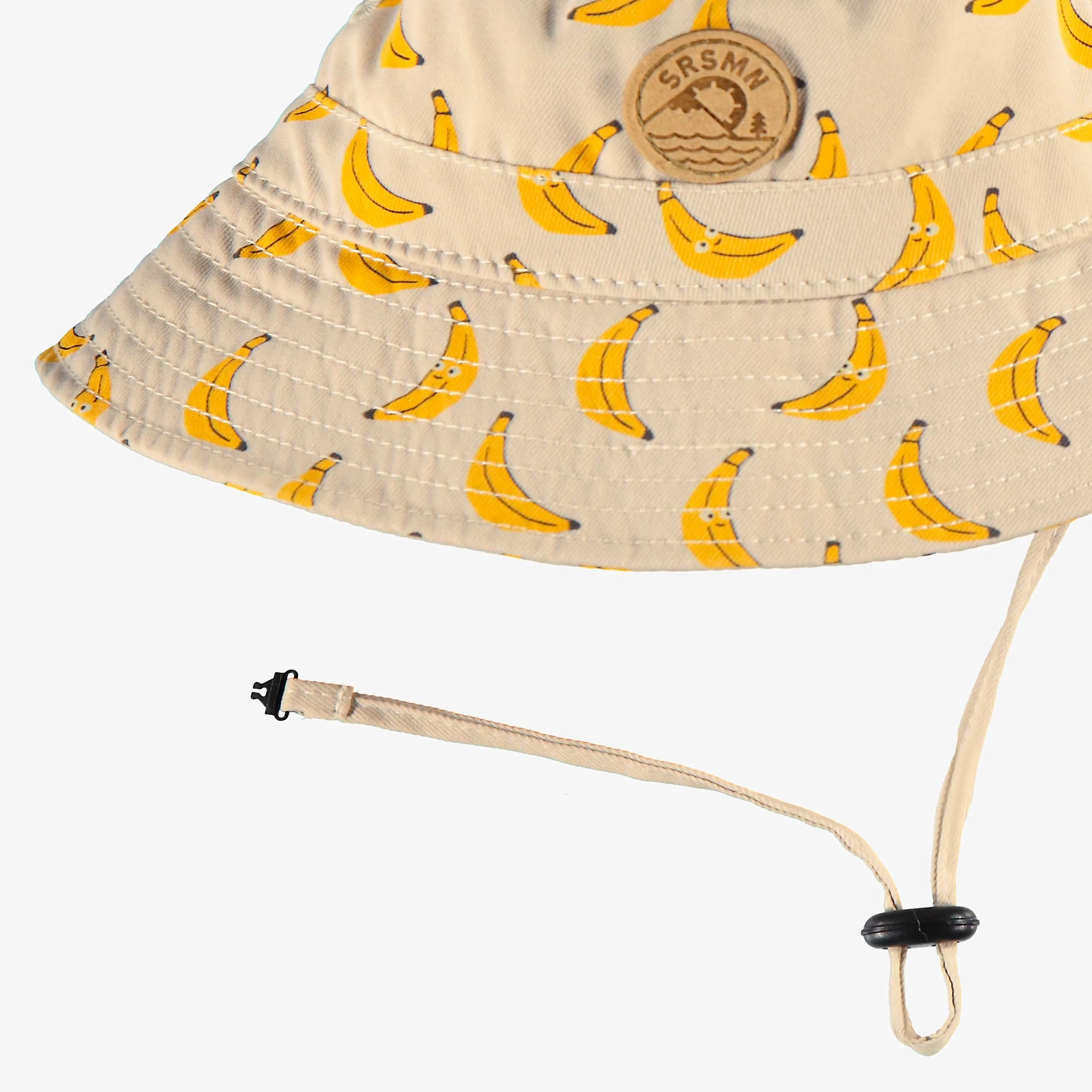 Chapeau de soleil beige en twill à motifs de bananes, bébé||Beige twill sun hat with banana all over print, baby
